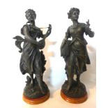 Two spelter figures of young ladies, one holding wheat sheaths and the other playing a lute,