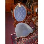 A Victorian walnut nursing chair, with deep buttoned blue velour upholstery and carved frame, H.