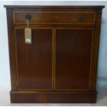 A 20th century inlaid mahogany side cabinet, with single drawer over two cupboard doors, raised on