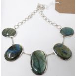 A large and weighty sterling silver necklace set with five graduated labradorite cabochon panels, L: