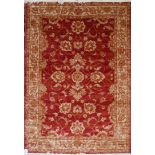 A Zeigler style rug with floral design on a red ground, contained by floral border, 190 x 140cm