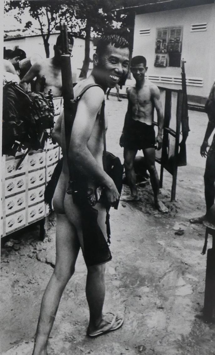 Don McCullin (British, b.1935), Cambodia 1970, a Cambodian soldier wearing a gun, silver gelatin