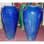 Two Persian blue glazed twin handled Sharab wine vessels of tapered form, H.83 W.51cm (largest) (2)