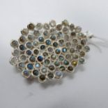 A large sterling silver pendant inset with sixty-seven collet-set round moonstone cabochons to a