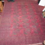 A large antique Russian Afghan Bokhara carpet, with gull motifs on a red and black ground, contained