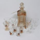 A 19th century glass decanter with hand painted hunting scenes and a collection of matching