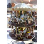 A set of 24 Franklin mint 'Treasury of Carousel Art' animals with spinning carousel display case and