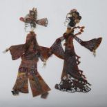 A pair of Javanese shadow puppets, comprising a man and women in traditional dress, H.33cm