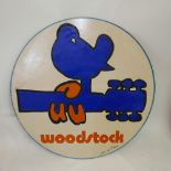 A vintage Woodstock adverting sign, signed by Gavin Du Plessis and dated 1994, Diameter 75cm