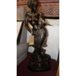 A large 20th century bronze statue of an Indian goddess holding a bird, H.87cm