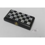 A JAPANESE TRAVELLING CHESS SET, Inlaid mother of pearl board and ox horn chess pieces c.1900 A/F¦