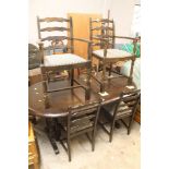 AN OAK DRAW LEAF TABLE TOGETHER WITH SIX LADDER BACK CHAIRS