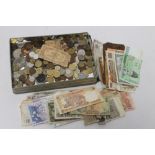 A TIN OF ASSORTED WORLD COINS AND BANK NOTES