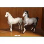 A BESWICK DAPPLE GREY HORSE TOGETHER WITH A BESWICK ARAB DAPPLE GREY PRANCING PONY