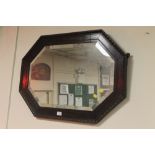 AN OAK FRAMED WALL MIRROR