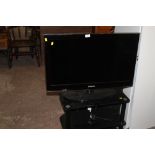 A SAMSUNG FLATSCREEN TV AND STAND