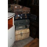 A TIN TRUNK TOGETHER WITH A QUANTITY OF VINTAGE SUITCASES AND A VINTAGE WOODEN STORAGE DRAWERS