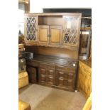 A LARGE OAK DRESSER WITH LEADED GLASS DOORS