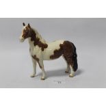 A BESWICK SKEWBALD BROWN AND WHITE PONY