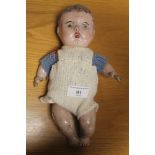 A VINTAGE COMPOSITION DOLL WITH JOINTED BODY AND PAINTED DETAIL. Length 28 cm¦Condition Report:In