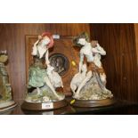 A PAIR OF CAPO DI MONTE FIGURES FEATURING A SHEPHERD AND SHEPHERDESS WITH LAMBS