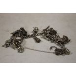 A VINTAGE SILVER CHARM BRACELET