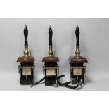 THREE VINTAGE BAR PULLS, WITH BLACK CERAMIC HANDLES, brass fittings, mounted on wood bases (3)