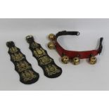 TWO STRAPS OF HORSE BRASSES WITH THE ARMS OF BIRMINGHAM, along with a strap of brass rumbler bells