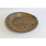 A RUSTIC TURNED WOOD SHALLOW BOWL, with crude metal repairs D 47 cm