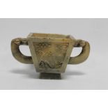 ORIENTAL / CHINESE INTEREST, CARVED TWIN HANDLED SOAPSTONE CUP, depicting fish to the one side