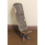 AN AFRICAN CARVED WOOD FOLDING CHAIR, the back carved with giraffe figures