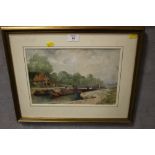 A FRAMED AND GLAZED WATERCOLOUR OF A CANAL WITH BARGES SIGNED LOWER RIGHT