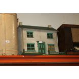 A VINTAGE WOODEN DOLLS HOUSE