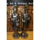 A PAIR OF CAST WHITE METAL EFFECT ORIENTAL STYLE FIGURES