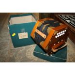 A BOXED CONCERTINA SQUEEZE BOX