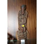 A VINTAGE CARVED WOODEN EASTERN DEITY FIGURE