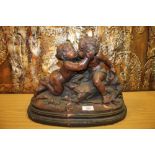 A CERAMIC SCULPTURE OF A YOUNG BOY AND GIRL KISSING A/F