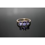 A HALLMARKED 9 CARAT GOLD TANZANITE RING, set with three pear shaped tanzanites, approx weight 2.2g,