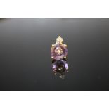 A HALLMARKED 9 CARAT GOLD AMETHYST AND DIAMOND PENDANT, measuring approx 10 mm x 10 mm