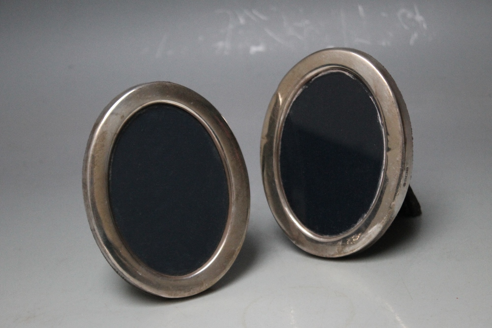 A PAIR OF HALLMARKED SILVER PHOTO FRAMES - SHEFFIELD 1987, oval in form, H 11 cm