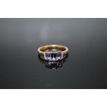 A HALLMARKED 9K GOLD THREE STONE TANZANITE RING, the largest measuring approx 6 mm x 4 mm, ring size