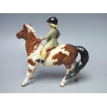 A BESWICK GIRL ON SKEWBALD PONY, green jacket, model number 1499, S/DCondition Report:Damage to