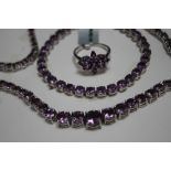A SILVER AND AMETHYST JEWELLERY SET, consisting of a ring, graduating necklace and a bracelet (3)