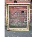 AN ANTIQUE CARVED GILTWOOD PICTURE FRAME, with egg and dart moulded detail, rebate 86 x 69 cm