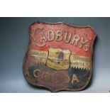 AN EARLY 20TH CENTURY SHIELD SHAPED CADBURY'S COCOA TIN PLATE SIGN, with damages, H 52.5 cm, W 51