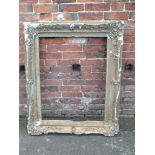 A LARGE ANTIQUE GILTWOOD PICTURE FRAME, foliate moulded detail throughout, rebate 90 x 70 cm A/F