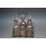 A SILVER PLATED SIX BOTTLE CRUET- MAKERS MARK FOR C.T. & Co., with scrolled gallery & shield
