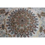 A LARGE ANTIQUE CIRCULAR WOOLLEN RUG, having central Eastern cartouche, floral design throughout,
