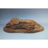 A MODERNIST WOODEN SCULPTURE OF A RECLINING FEMALE NUDE, on a wooden base, unsigned, H 15 cm, L 46