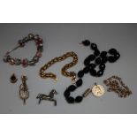 A BAG OF COSTUME JEWELLERY TO INCLUDE A GOLD MOUNTED SMOKEY QUARTZ PENDANT, jet necklace etc.